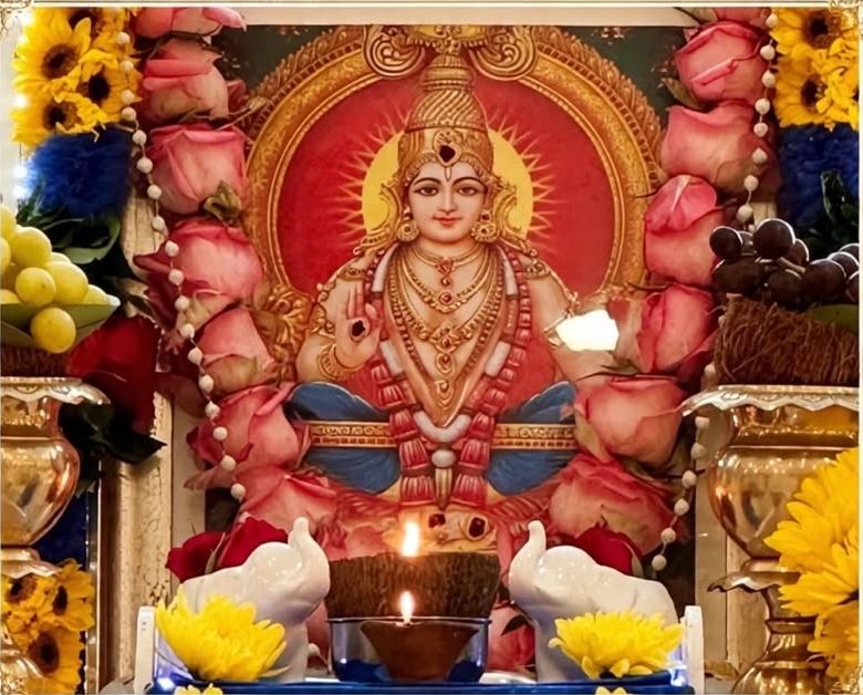 Lord Ayyappa adorned with roses, sunflowers and a lit vilakku at Bradford Hindu Temple